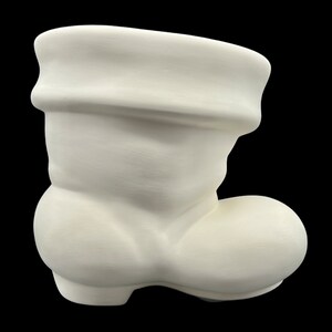 May include: White ceramic Santa boot planter. The boot has a folded cuff at the top and a rounded toe.