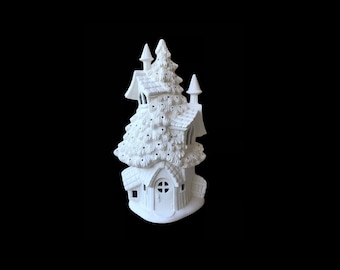 May include: White ceramic house shaped like a tree with a door and windows. The house is a blank canvas for painting.