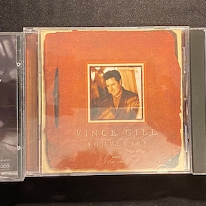 May include: Three compact discs featuring country music artist Vince Gill. The album covers display images of Gill and album titles including "When I Call Your Name", "Souvenirs", and "The Key". The CDs are in clear plastic cases.