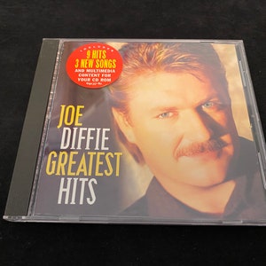 May include: A Joe Diffie Greatest Hits CD in a clear plastic case. The album cover features a portrait of the artist with text that reads "9 Hits 3 New Songs" and "Greatest Hits".