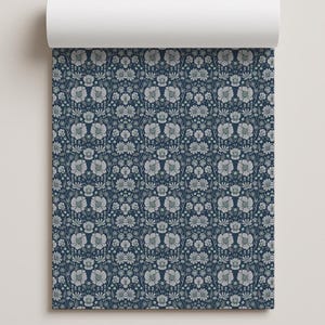 May include: A roll of wallpaper featuring a repeating pattern of light grey flowers, leaves, and stems set against a dark navy blue background. The design displays a dense, symmetrical arrangement of botanical elements across the entire surface.
