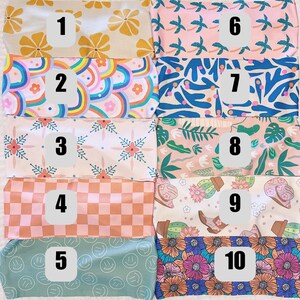 May include: Ten fabric swatches with numbers 1 through 10 on them. The swatches feature various patterns, including floral, geometric, and abstract designs. The swatches are all in pastel colours.