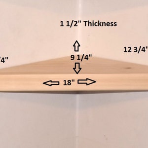 May include: A light-colored wooden corner shelf with dimensions labeled: 1 1/2" thickness, 12 3/4" along the sides, 9 1/4" depth from the corner to the front edge, and 18" across the front edge. The shelf is triangular with a curved front.