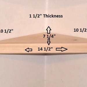 May include: A light-colored wooden corner shelf with dimensions labeled: 10 1/2 inches for the sides, 14 1/2 inches for the front edge, 7 1/4 inches for the depth, and 1 1/2 inches for the thickness, shown against a plain white background.