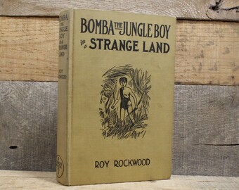 Bomba The Jungle Boy in a Strange Land, Roy Rockwood, 1931 Yellow cloth hardcover with black lettering, red top pages, Jungle Stories
