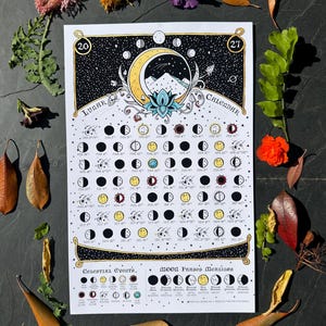 May include: A 2027 lunar calendar poster featuring a central illustration of a crescent moon, mountains, and a lotus flower. The design includes a grid of moon phases with dates, a celestial events section, and a moon phases meanings guide.