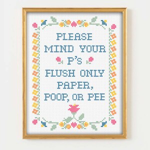 May include: A framed cross-stitch design with a white background and a colorful floral border. The text reads "Please mind your P's Flush only paper, poop, or pee."