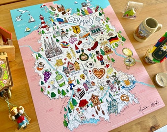 May include: A colorful illustrated map of Germany with various landmarks, symbols, and icons representing different cities and regions. The map is on a pink background with a blue border. The text "GERMANY" is written in black at the top of the map.