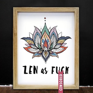 May include: A framed art print featuring a colorful lotus flower illustration. The artwork includes a variety of colors, including blue, orange, and purple. The text "ZEN as FUCK" is displayed below the flower in bold, black letters.