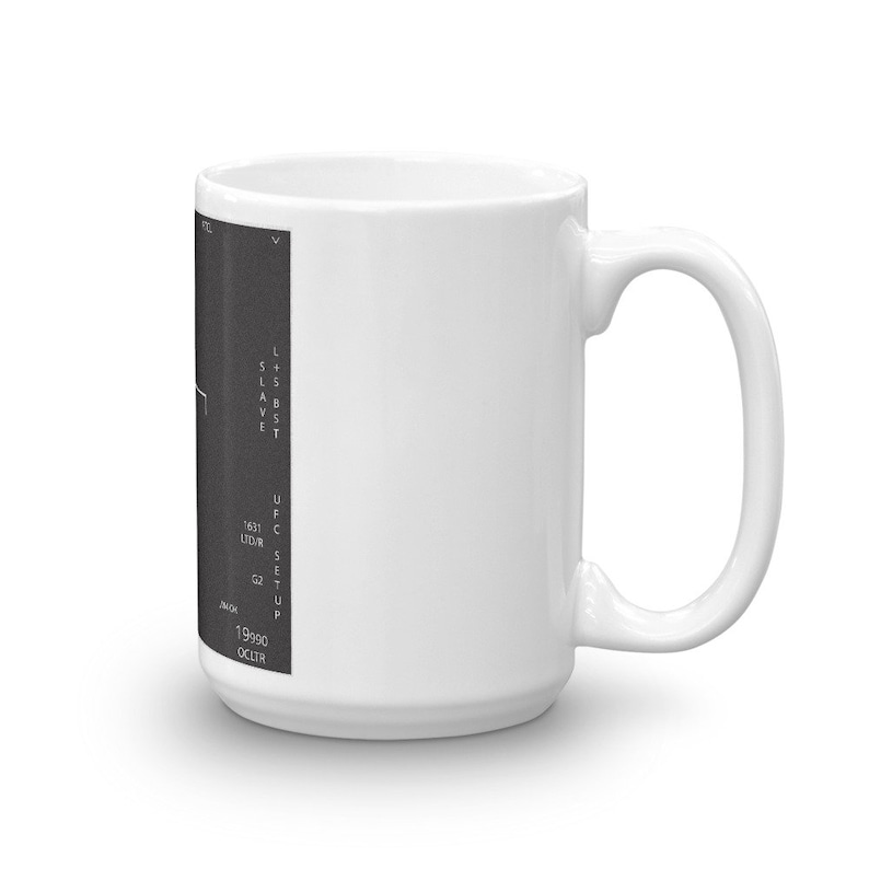 May include: White ceramic mug with a black and white graphic of a computer screen with text that reads "L+S BST SLAVE UFC SETUP 1631 LTD/HR G2 JAN/90 OCC/IR".