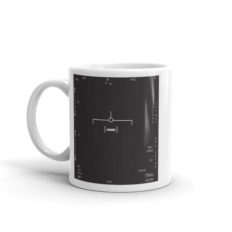 May include: White ceramic mug featuring a black and white image of a radar screen. The screen shows a target with the text "IR 4'" and "RTCL" at the top. The text "1631 LIDAR" and "19990 OCLTR" is displayed on the right side of the screen.