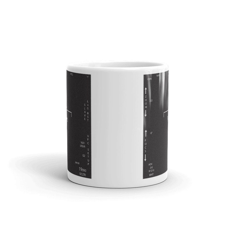 May include: A white ceramic mug featuring a black and white image of a medical scan on one side. The scan includes text that reads "OPR", "ZOOM", "131", "UDR", "S", "E", "QT", "19990", "OCLTR", "U", "ADV", "22", "MOSS", "WHT", and "U".