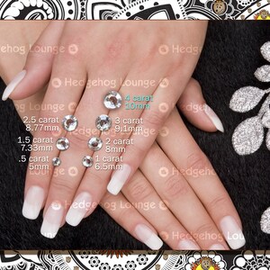 May include: Close-up of a hand with several clear rhinestones of different sizes. The rhinestones are labeled with their carat weight and size in millimeters. The largest rhinestone is 4 carat, 10mm. The smallest rhinestone is .5 carat, 5mm.