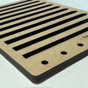May include: A wooden craft board with 10 slots for making bracelets. The board is brown with black edges and has the text "Sleekheart Creations" printed on the bottom right corner.