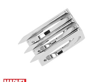 May include: A silver ring with three claw-like prongs. The ring is designed to resemble Wolverine's claws from the Marvel comics.