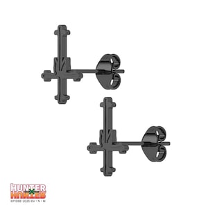 May include: A pair of black stud earrings featuring an inverted cross design. The earrings have a matte finish and a post-and-clutch closure. The image also includes the text "HUNTER X HUNTER" and copyright information.