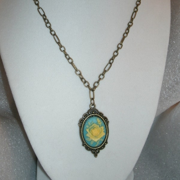 Roses Cameo turquoise background and ecru/yellowish raised flowers, resign, 18 by 13mm, bronze chain and antiqued setting