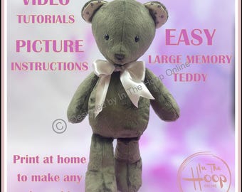 May include: A green plush teddy bear with a white satin bow. The bear is standing on a pink background. The text "VIDEO TUTORIALS PICTURE INSTRUCTIONS EASY LARGE MEMORY TEDDY" is written in pink letters on the background. The text "Print at home to make any size teddy" is written in pink letters at the bottom of the image. The text "Designed by In The Hoop Online" is written in white letters on the bear's body. The text "In The Hoop Online" is written in white letters on a white circle with a black border at the bottom right of the image.