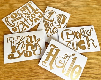 5 greetings cards, hand printed linocut designs in gold ink