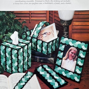 May include: An ensemble of handmade items with a green and black braided pattern. The set includes a tissue box cover, eyeglass case, bookmark, frame, and basket. The text reads "Eye-catching Ensemble".
