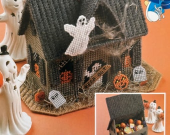 May include: A handmade Halloween-themed house with a gray roof, a white ghost, and orange pumpkin decorations. The house has a "Keep Out" sign and a "RIP" tombstone. Two white ghost figurines with orange pumpkins are on the left.