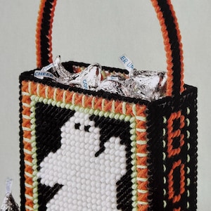 May include: A black and orange canvas tote bag with a white ghost design and the word "BOO" on the side. The bag is filled with foil-wrapped chocolate candies.