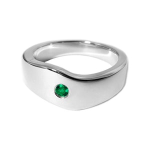 May include: A silver ring with a wave-like design and a small green gemstone set in the centre.