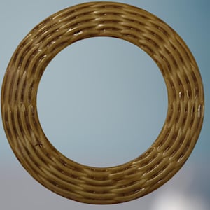 May include: A circular, woven-style decorative ring in a warm, golden-brown hue. The ring's texture features a repeating pattern of interwoven lines, creating a textured surface. The ring is set against a soft, gradient blue background.