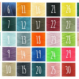 May include: A color chart of 33 different shades of thread spools. The spools are arranged in rows of six, with the numbers 1 through 33 printed on each spool.
