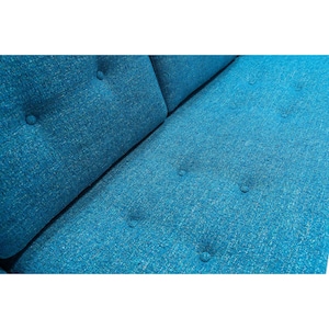 May include: Close-up of a teal blue sofa with button tufting. The fabric has a subtle texture.