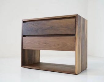 May include: A two-drawer nightstand with a lower open shelf, made of dark wood with a natural wood grain finish.