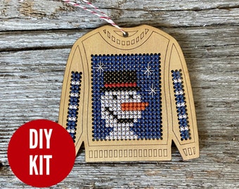 Ugly sweater with cheerful snowman holiday ornament cross stitch kit on laser cut wood