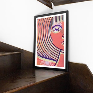 May include: A framed print of a colorful abstract portrait of a person with a striped hairstyle and a single eye. The background is a light orange color with a white starburst.