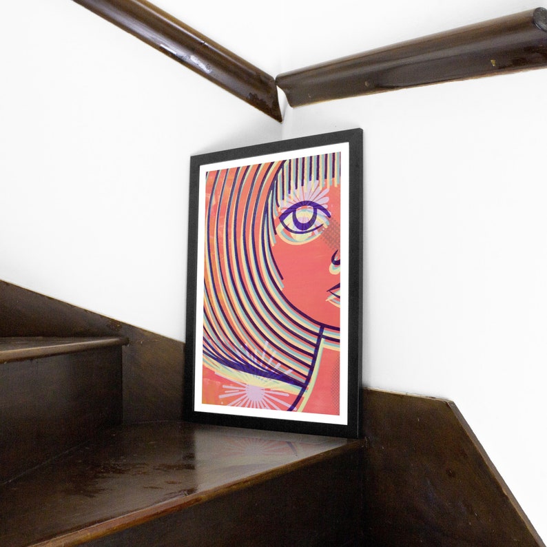 May include: A framed print of a colorful abstract portrait of a person with a striped hairstyle and a single eye. The background is a light orange color with a white starburst.