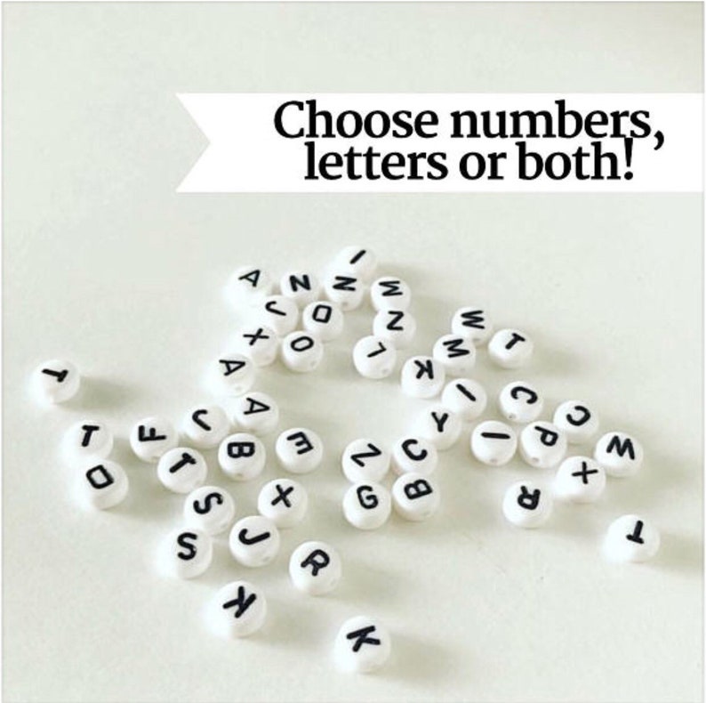 May include: White round beads with black letters and numbers. The beads spell out the words "Choose numbers, letters or both!"