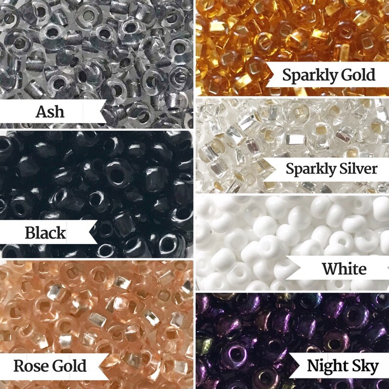 May include: Assortment of seed beads in various colors, including sparkly gold, sparkly silver, ash, black, white, rose gold, and night sky.