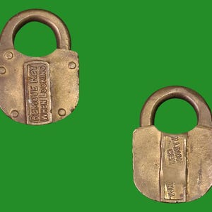May include: Two antique brass padlocks with arched handles. One padlock has the text "REMOVE KEY WHEN LOCKING". The other padlock has the text "ILLINOIS GEN WAL". Both are on a green background.