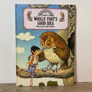 May include: A vintage children's book, "Woolly Foot's Good Idea", featuring an owl and a young elf. The cover shows a blue sky with clouds and the text "Rainbow's End". The illustration is by John Patience.