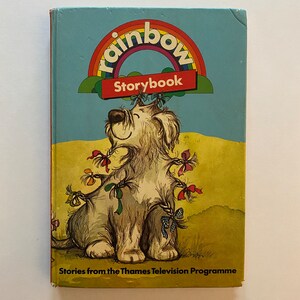 May include: A vintage children's book titled "Rainbow Storybook" featuring a cartoon dog with colorful ribbons and the text "Stories from the Thames Television Programme".