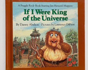 May include: A brown book cover with a Fraggle Rock character holding a pitchfork. The book title is "If I Were King of the Universe" by Danny Abelson. Pictures by Lawrence DiFiori.