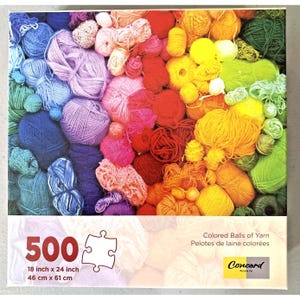 May include: A 500-piece jigsaw puzzle featuring a vibrant array of colored yarn balls. The puzzle image displays a spectrum of colors, including blues, greens, yellows, reds, and purples. The puzzle measures 18 inches by 24 inches.