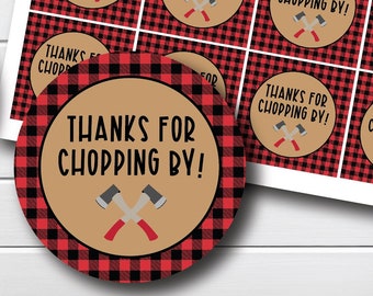 May include: A sheet of red and black buffalo plaid patterned paper with 12 round favor tags. Each tag has a brown circle with the text "Thanks for Chopping By!" and a pair of crossed axes.