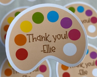 May include: Thank you! -Ellie. A brown paint palette with colourful paint dots and the text "Thank you! -Ellie".