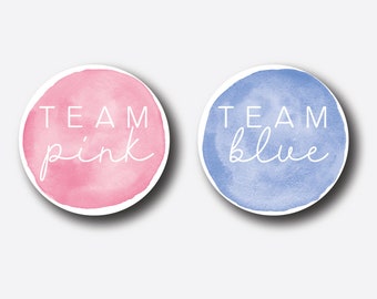 May include: Two round watercolor stickers with the text "Team Pink" and "Team Blue" in white. The pink sticker has a pink watercolor background and the blue sticker has a blue watercolor background.