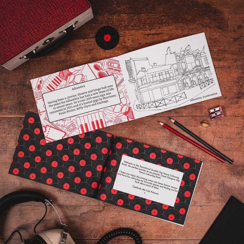 May include: An open colouring book with a black and white illustration of a building with the text "Alhambra, Dunfermline". The book is open to a page with a red and black pattern of vinyl records and text about the Alhambra.