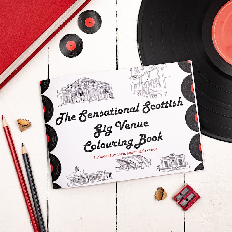 May include: A white colouring book with a black and white illustration of a building on the cover. The title of the book is "The Sensational Scottish Gig Venue Colouring Book" and it includes the text "Includes fun facts about each venue".