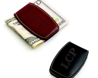 May include: Two leather money clips with the initials "LCP" engraved on them. One clip is burgundy and the other is black.
