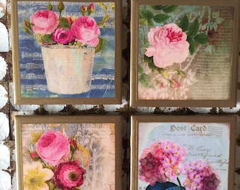 May include: Set of four square coasters featuring vintage floral designs. Each coaster has a gold border and a different pink floral pattern on a light background. The designs include roses, hydrangeas, and other flowers.