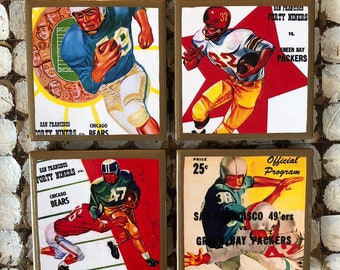 May include: Four vintage-style coasters featuring images of football players from the San Francisco Forty Niners and the Green Bay Packers. The coasters are square and have a gold border. The images are in a retro style with bright colors and bold lines. The text on the coasters includes the team names, "Official Program", and "Price 25c".