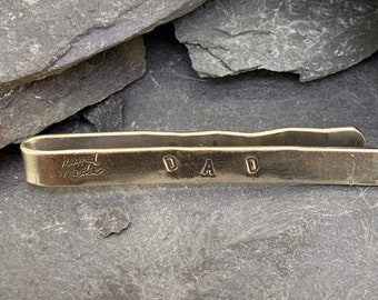 Sterling Silver tie pin with the word dad stamped onto the front